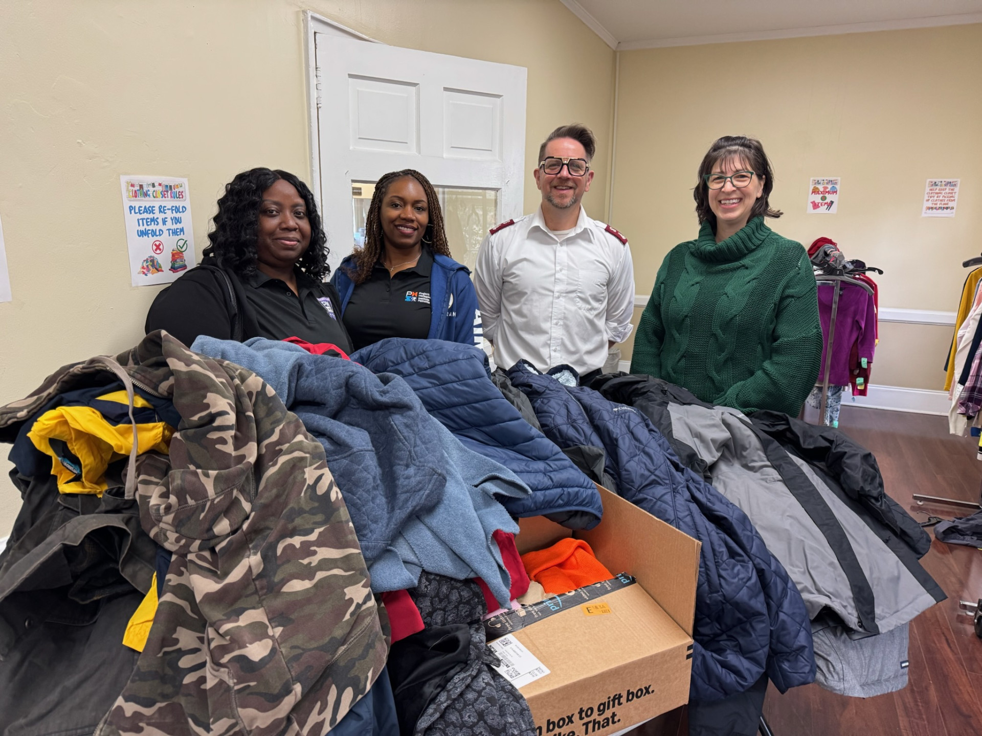 PMI Palmetto board members and Salvation Army representative pose with donated winter items.